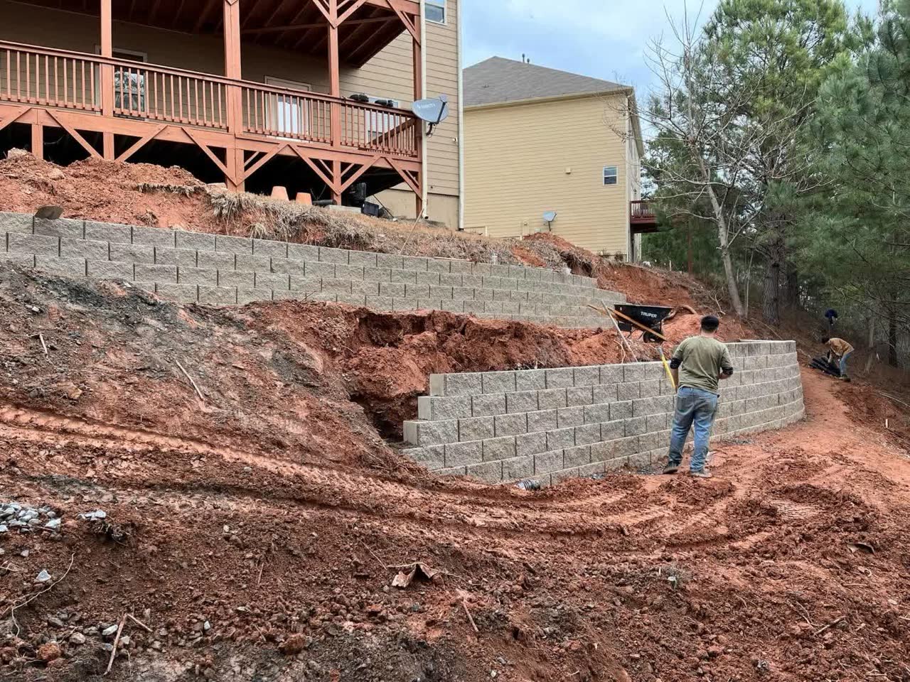 Custom stone retaining wall in a landscaped yard